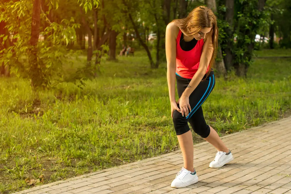 A woman experiencing heavy legs while running